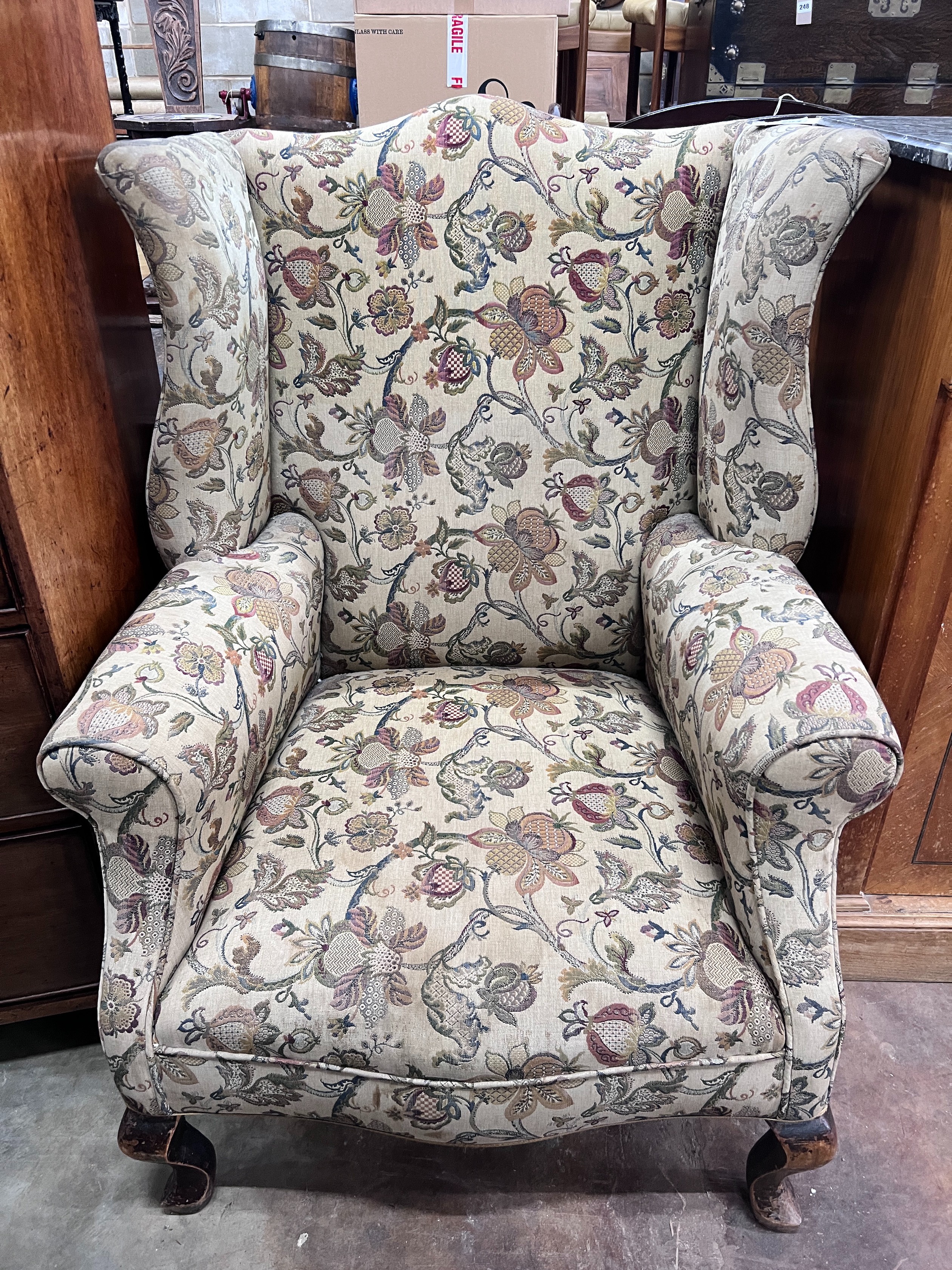 An early 18th century style mahogany wing armchair, width 78cm *Please note the sale commences at 9am.